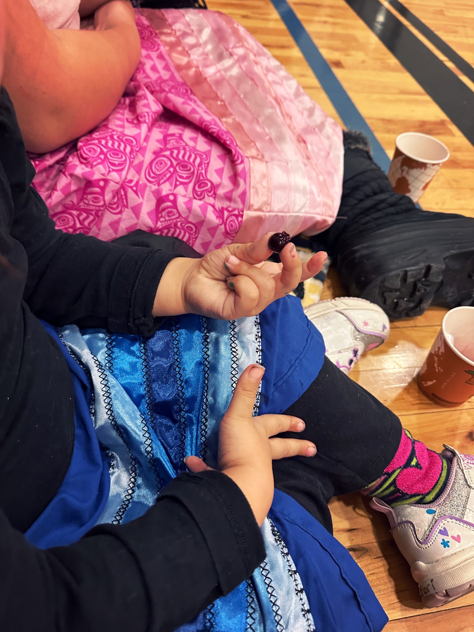 child holding saskatoon berry